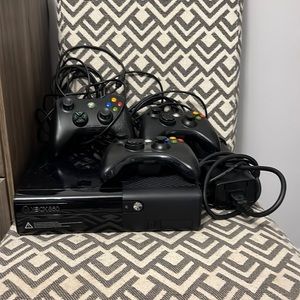 Xbox 360 with power cords and 3 controllers
